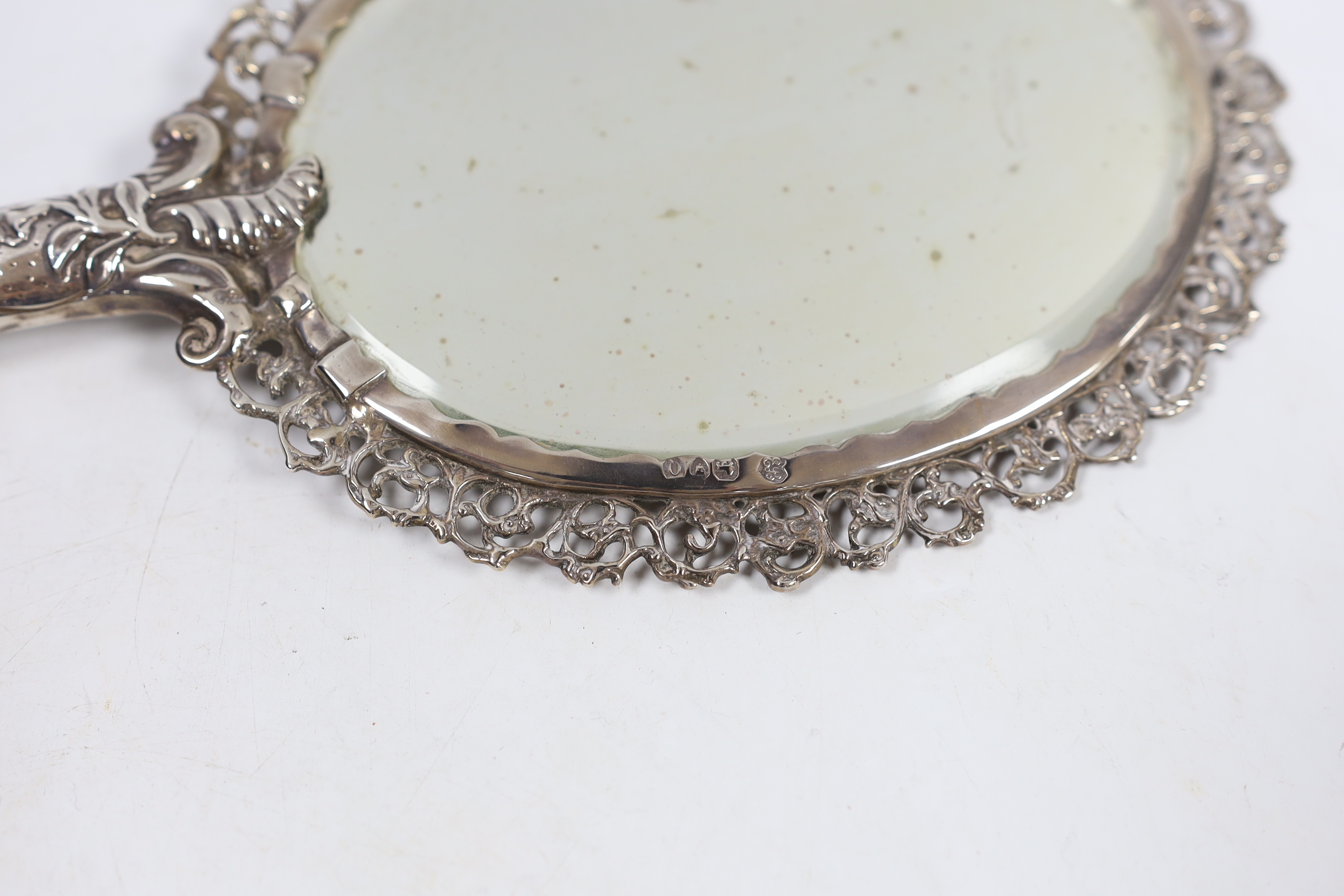 An ornate late Victorian silver mounted hand mirror, Edward Brown, London, 1891, 30.1cm.